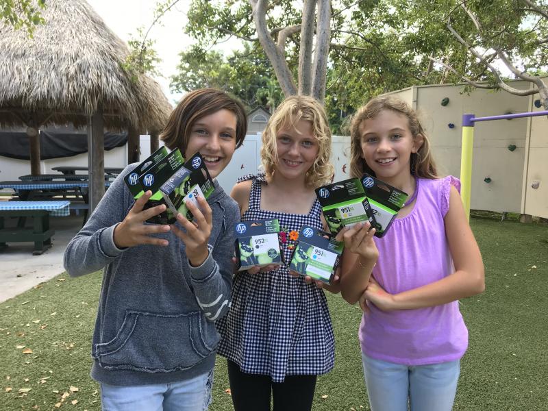 These young ladies say, ‘Thank you for the printer ink!’ The May Sands Montessori Upper Elementary students have been working on creative writing and they’re excited to be able to publish their stories.
